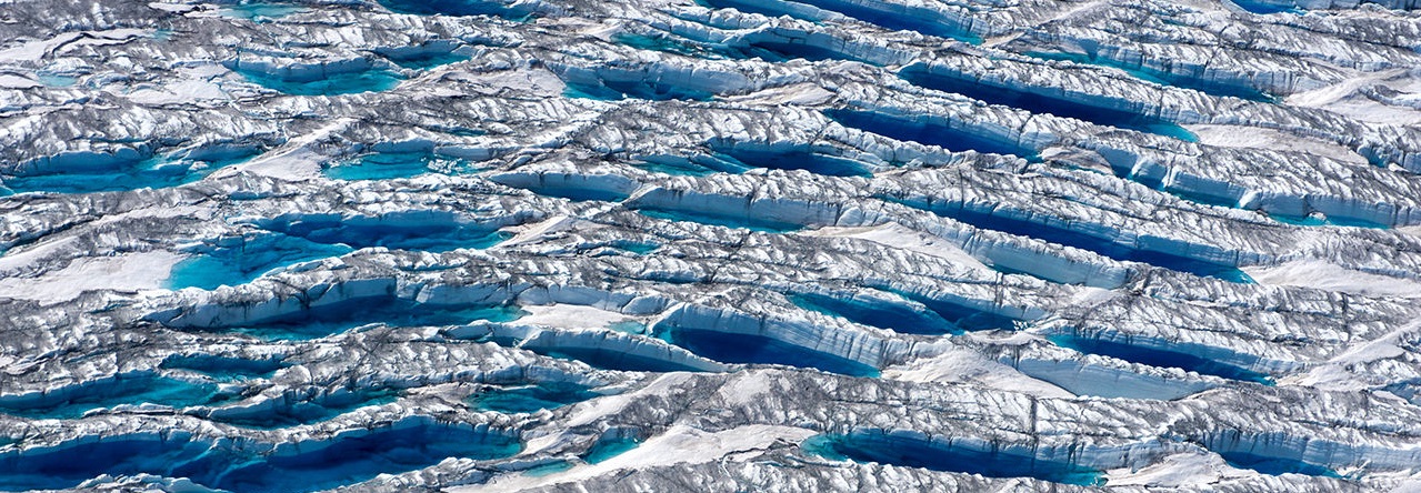 Rivers of meltwater and a mantle of soot, dust, and microbes all darken the ice and speed melting. Surface melting has now surpassed the discharge of icebergs into the ocean as the major cause of mass loss.